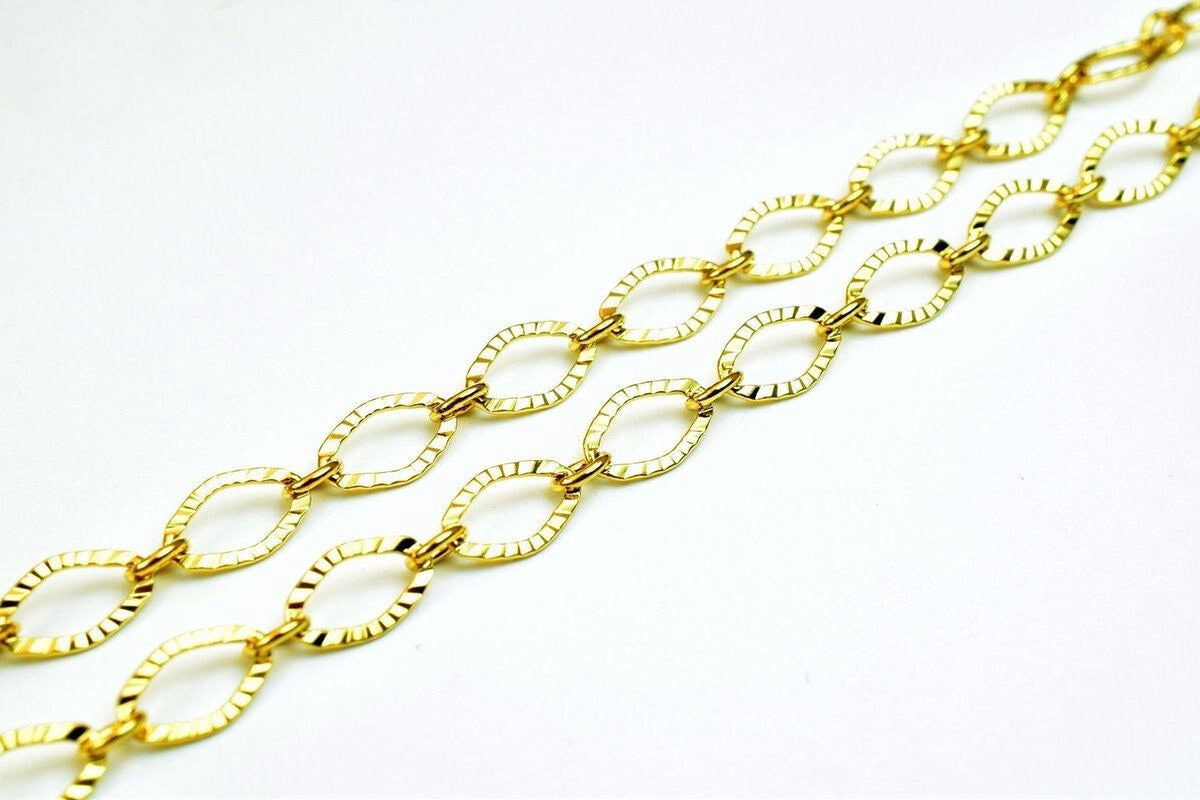 A close-up view of a gold chain necklace with multiple interlocking links.