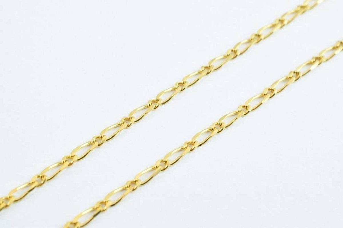 A close-up view of a gold chain necklace against a white background.