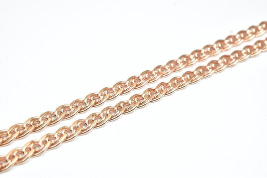 A close-up image of a chain with a metallic, reddish-brown color.