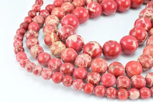 Red marble gemstone beads in assorted sizes for jewelry making.