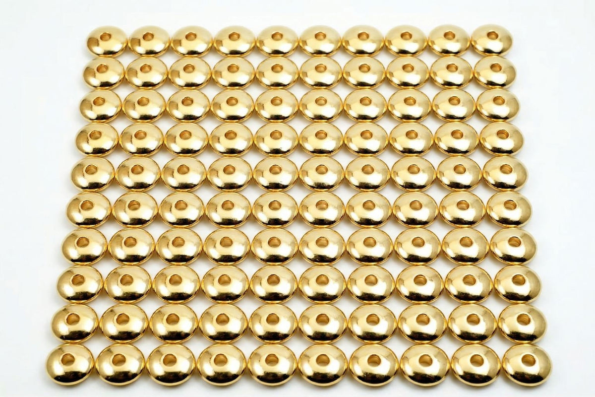 a grid of numerous gold-colored metal balls arranged in a repeating pattern.
