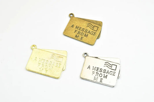 Gold and silver letter envelope charms with "A Message From Me" engraving.