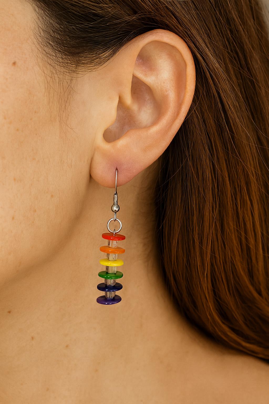 A pair of handmade drop earrings featuring colorful beads secured with gold head pins. The pins are neatly looped at the top, demonstrating how the gold-filled alternative wire holds its shape for professional jewelry design.