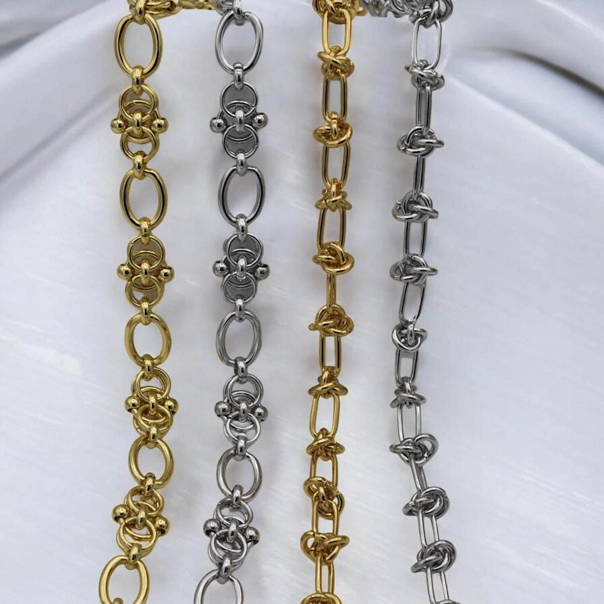 Gold chain with decorative knots and smooth finish, paired with matching findings for DIY jewelry kits.