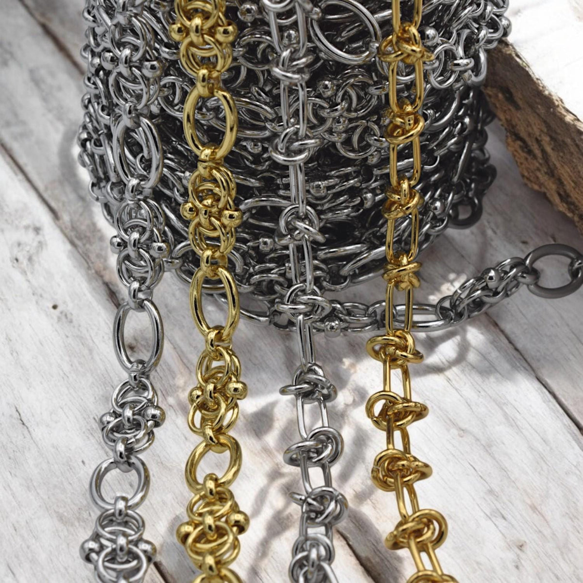 Silver knot chain photographed on a marble background, emphasizing its elegant and modern design.