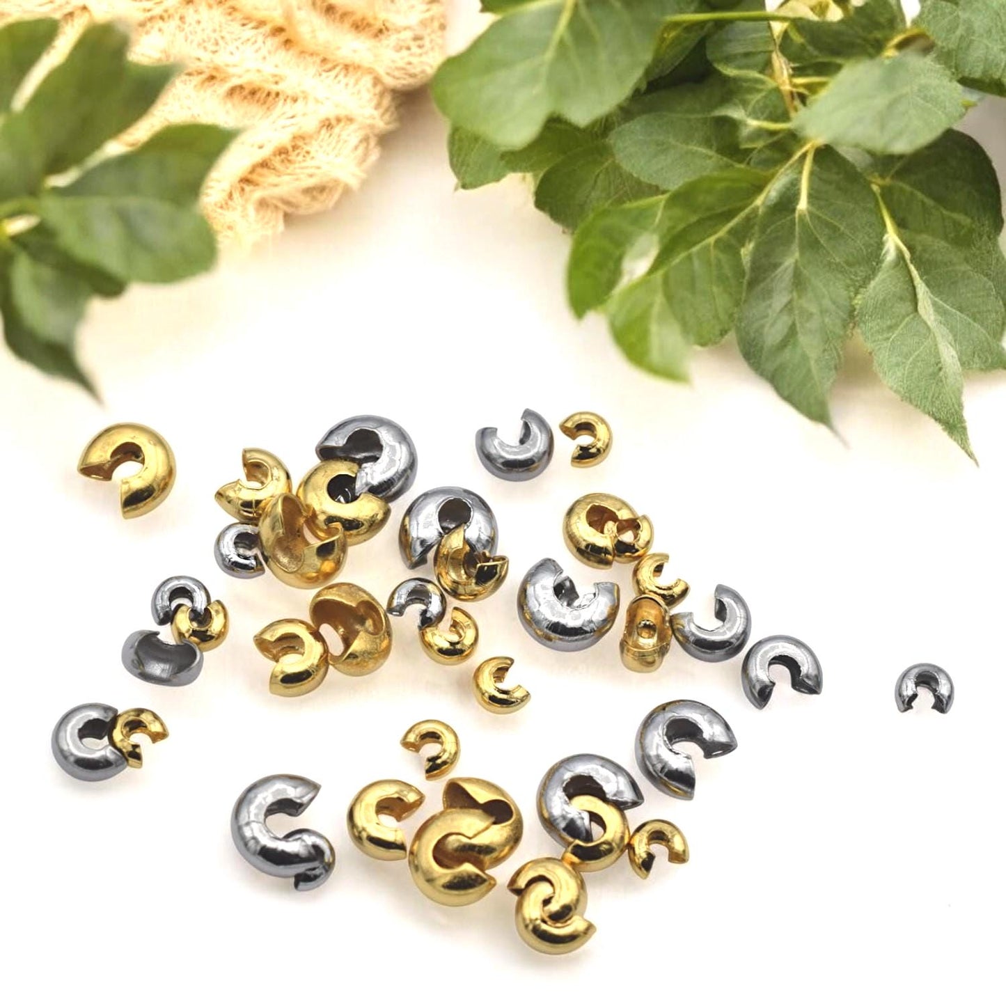 Gold stainless steel knot covers styled with finished beaded jewelry pieces, highlighting their polished look.