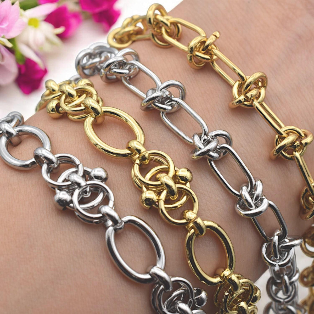 Macro shot of knot-style chain links in gold finish, showing texture and detail for product close-up.