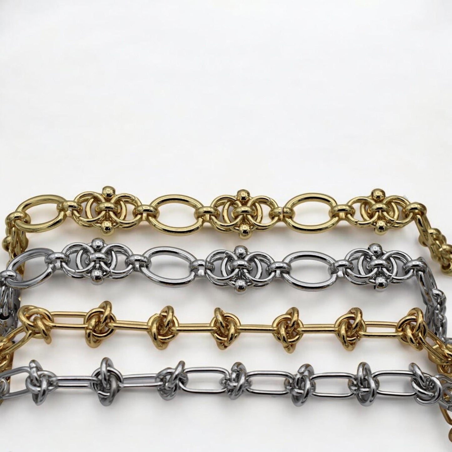 Silver chain with symmetrical knot motifs and rounded connectors, perfect for bold bracelet designs.