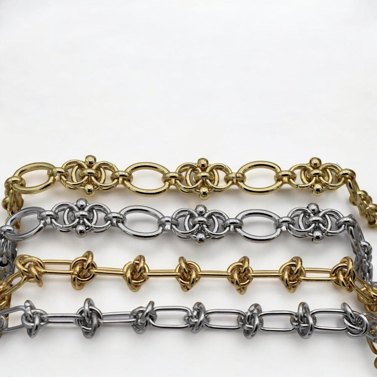 Silver chain with symmetrical knot motifs and rounded connectors, perfect for bold bracelet designs.