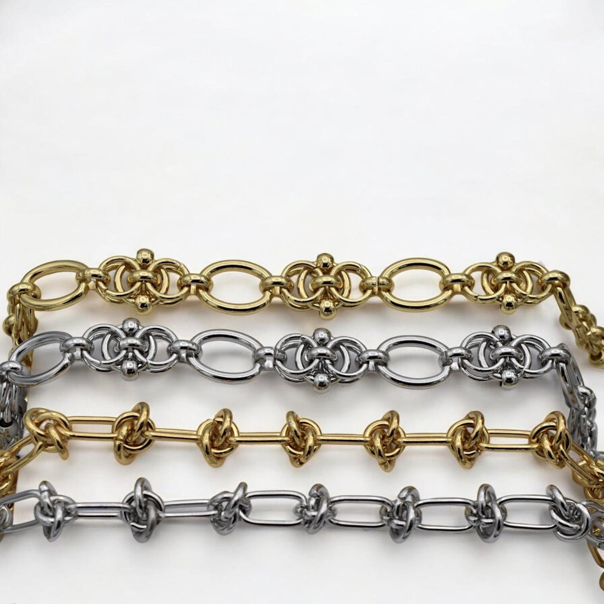 Silver chain with symmetrical knot motifs and rounded connectors, perfect for bold bracelet designs.