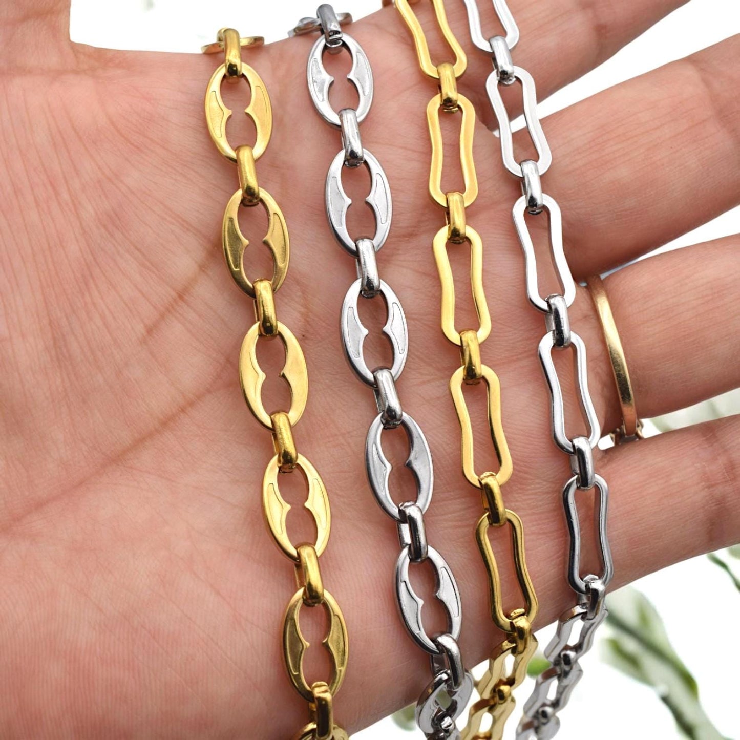 Close-up of gold-plated oval link chain with cutout center, ideal for chunky necklaces and bracelets