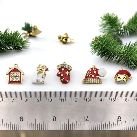 Festive red and white jewelry charms shaped like stocking, mitten, Santa hats, and holiday house with rhinestones.