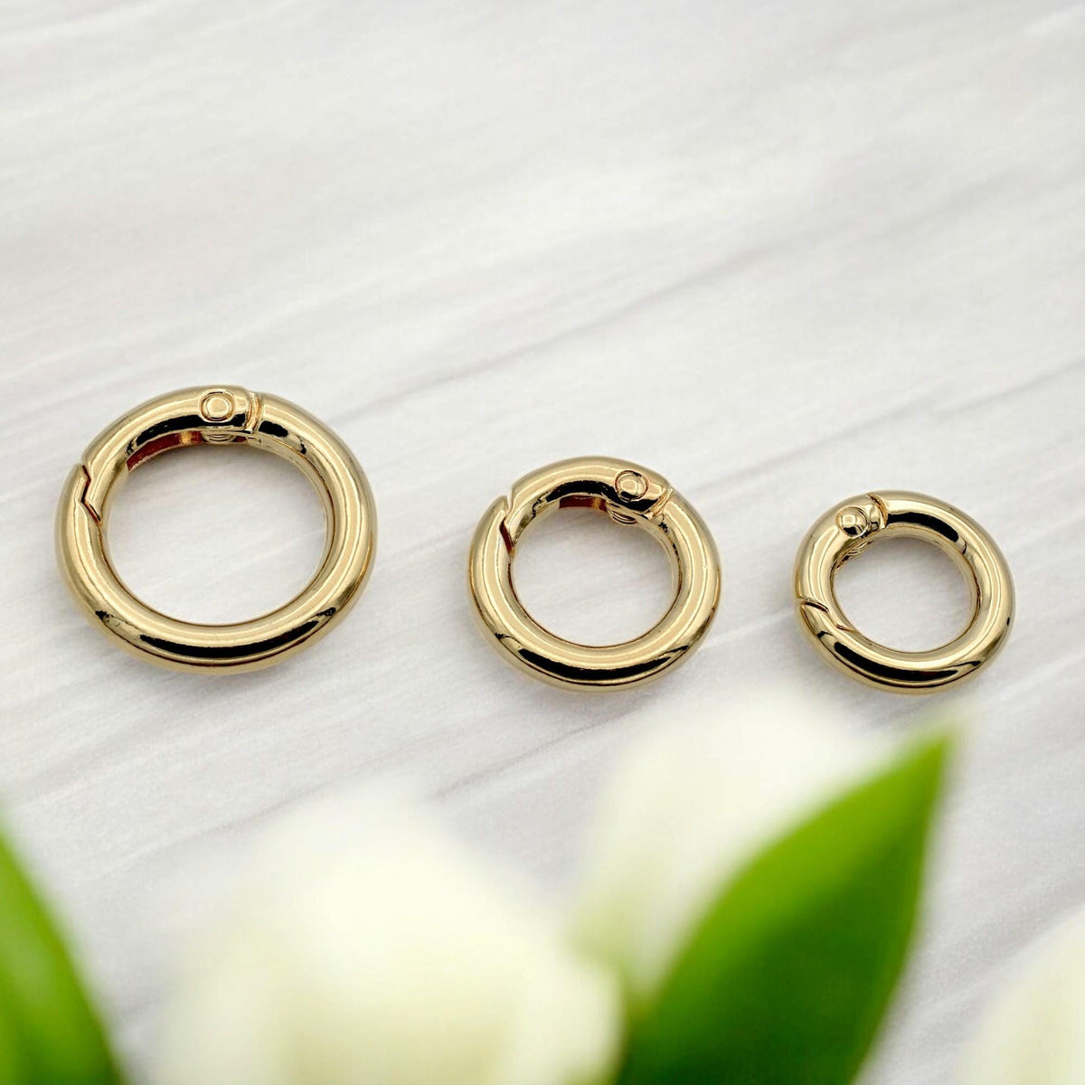 Jewelry connector ring in gold finish with spring gate and rotating base