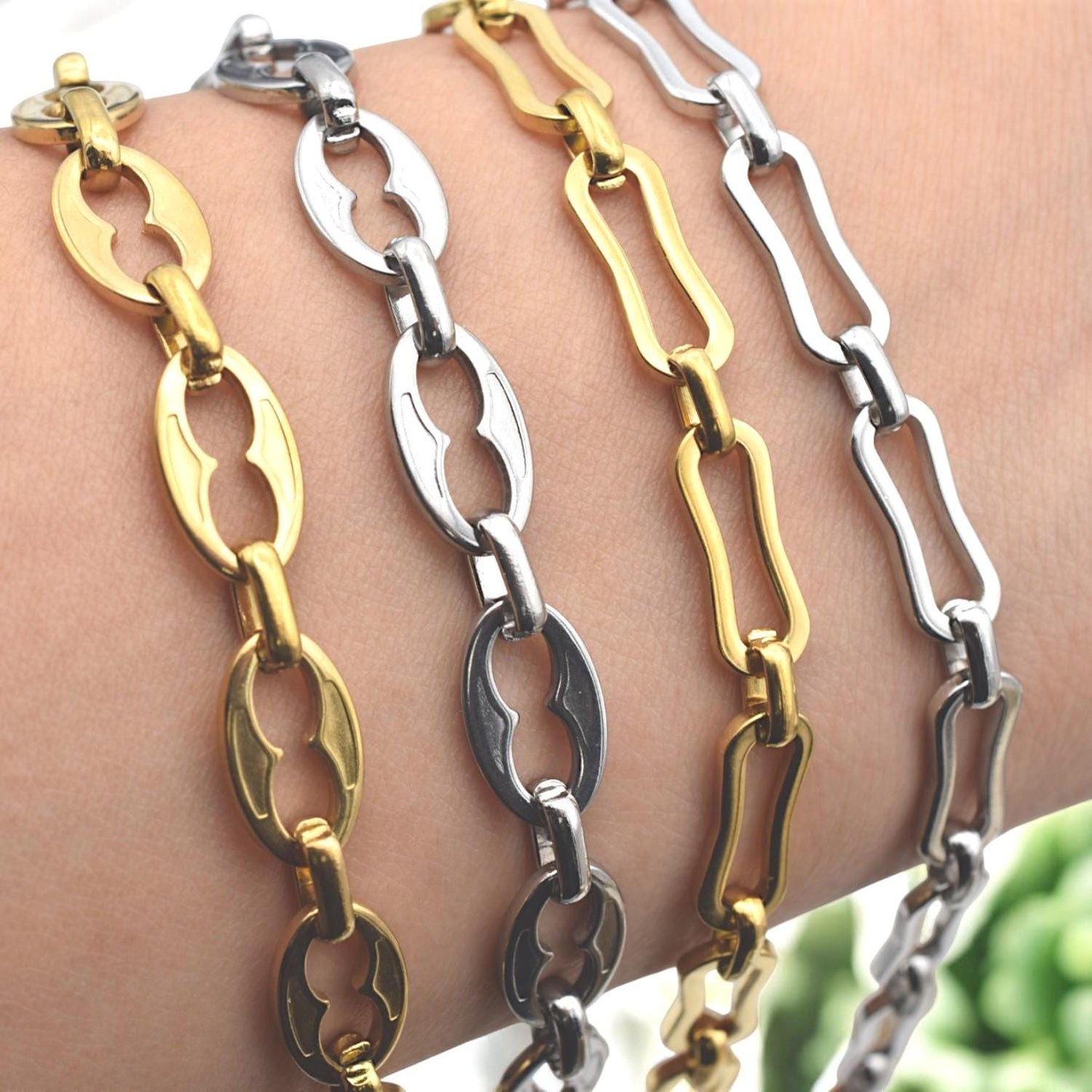 Smooth oval link chain with hollow center shown in bracelet stack arrangement