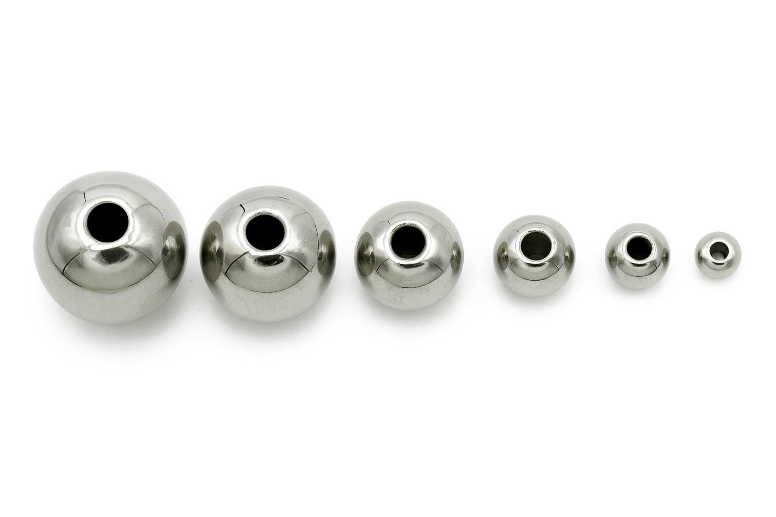 Set of plain silver-tone stainless steel beads arranged in rows from 2mm to 12mm
