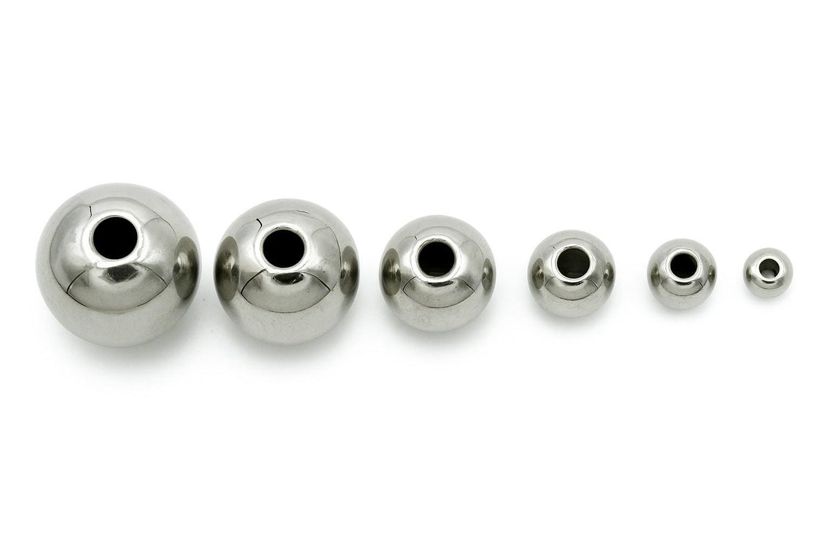 Set of plain silver-tone stainless steel beads arranged in rows from 2mm to 12mm