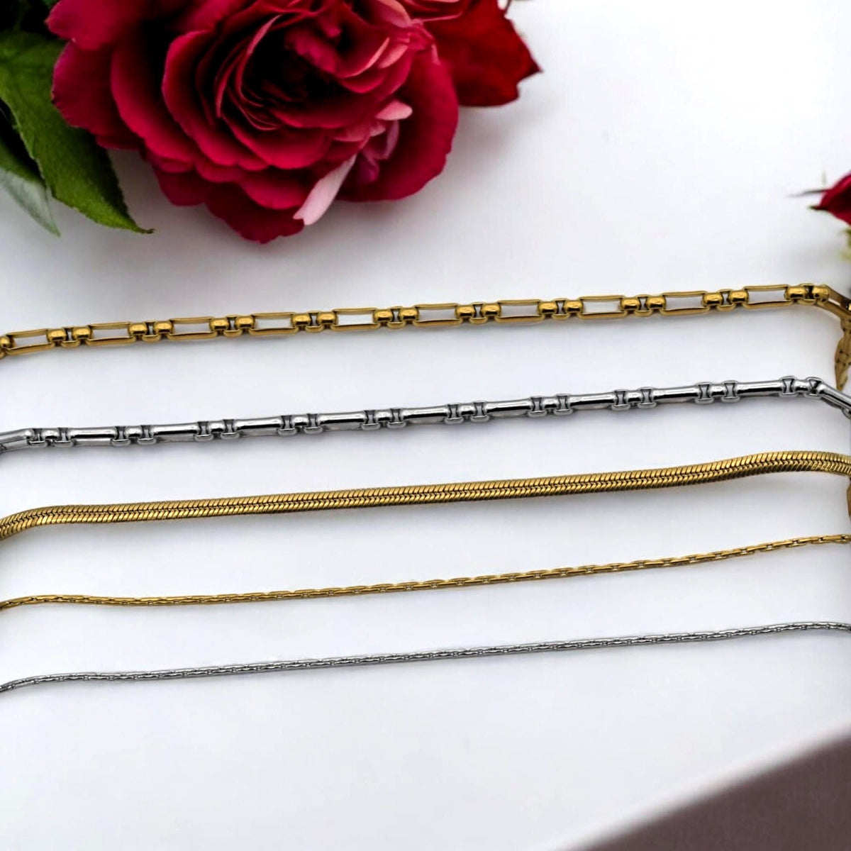 Layered necklace design using silver box chain and gold snake chain for DIY jewelry inspiration.