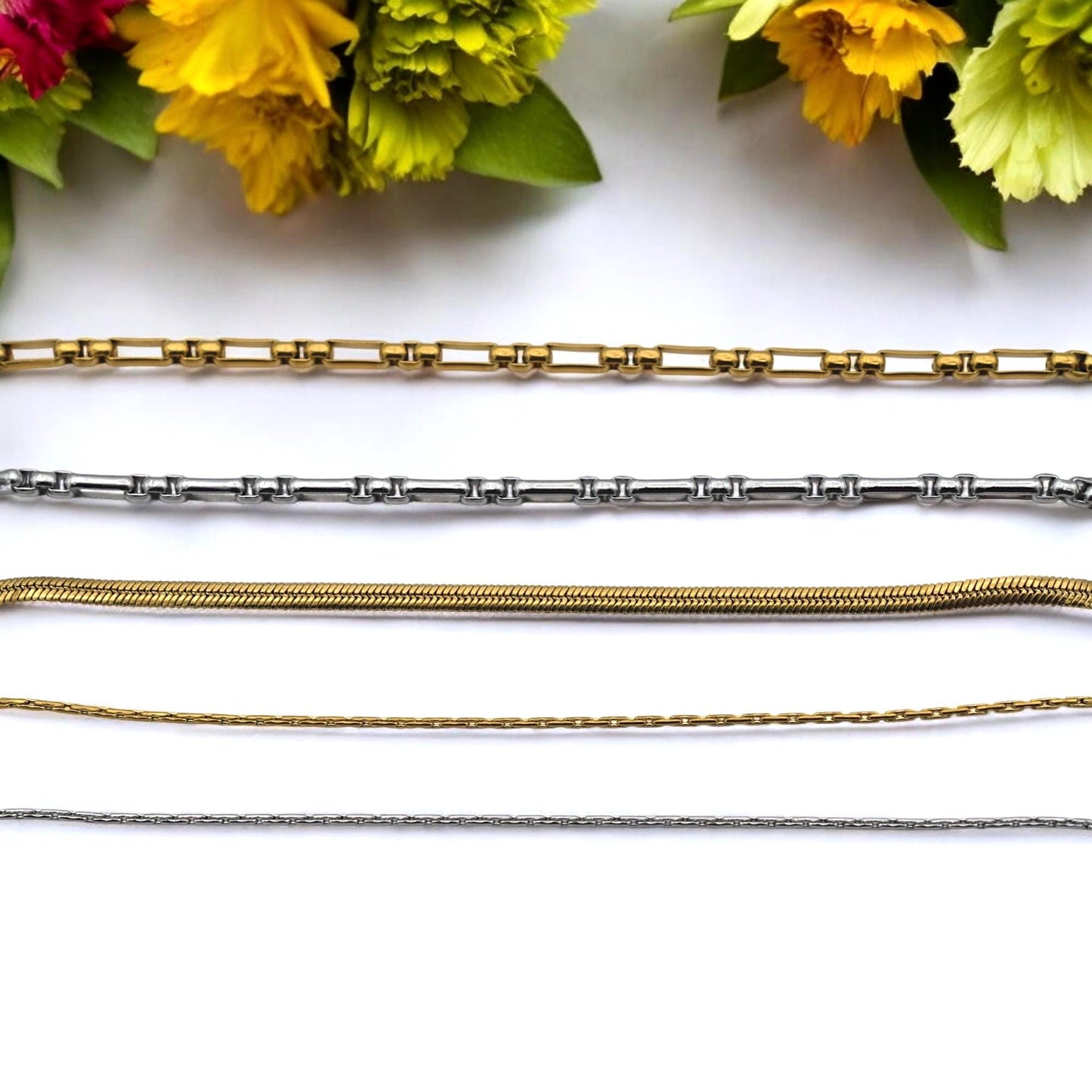Wholesale bundle of stainless steel chains in gold and silver, 11 yards packaged together.