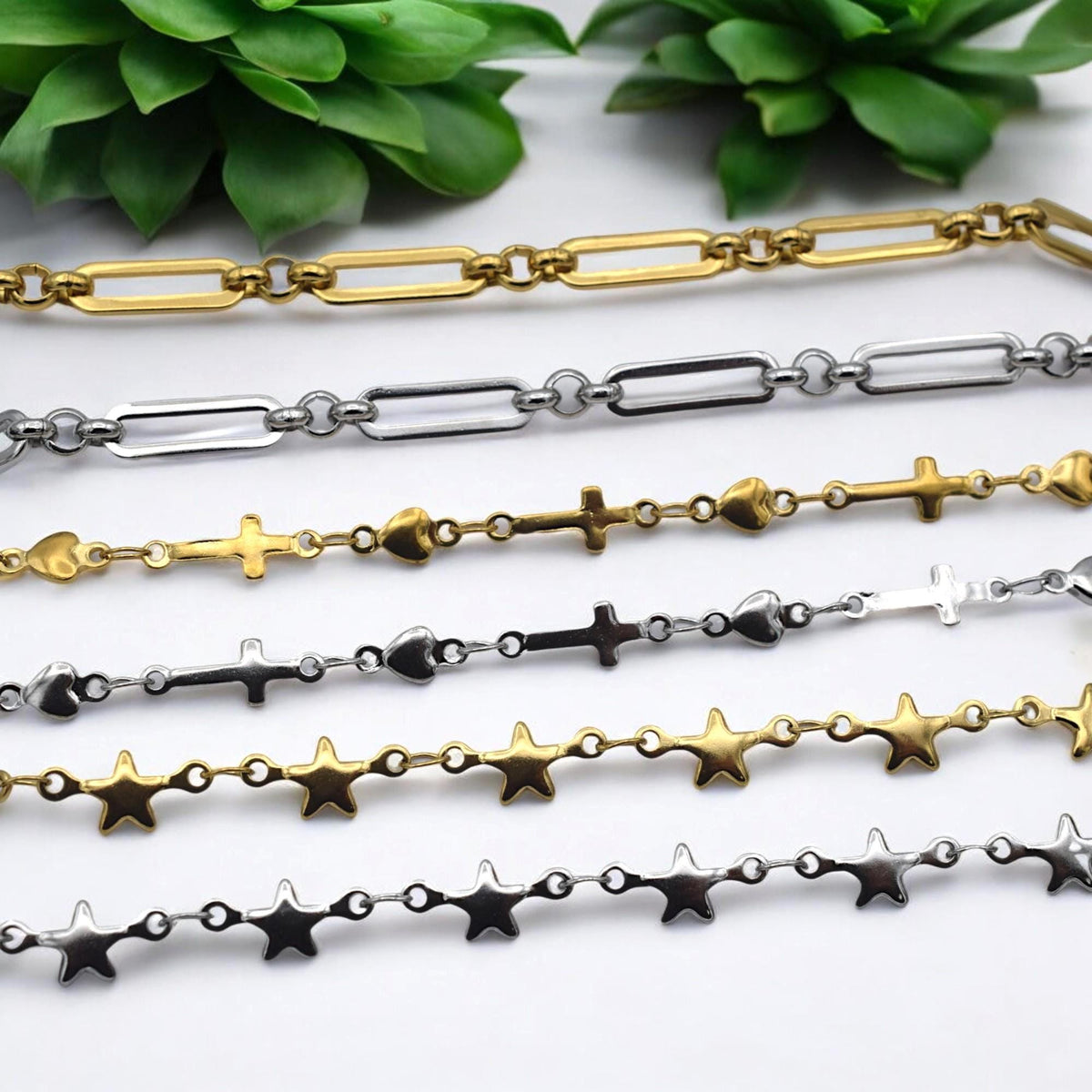Gold tone stainless steel paperclip chain with heart and cross charms for DIY necklaces.