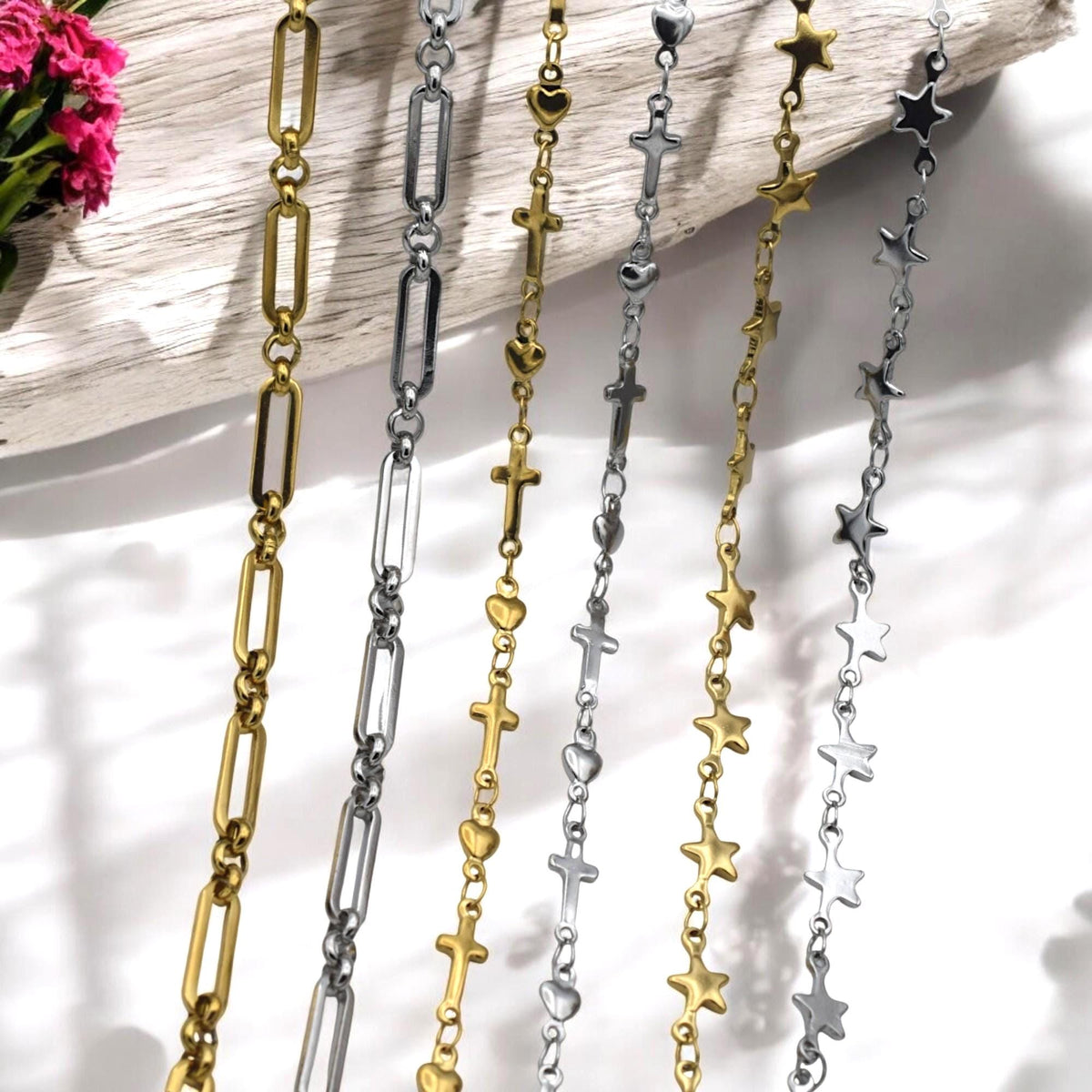 Mixed gold and silver stainless steel link chains with star and heart connectors.