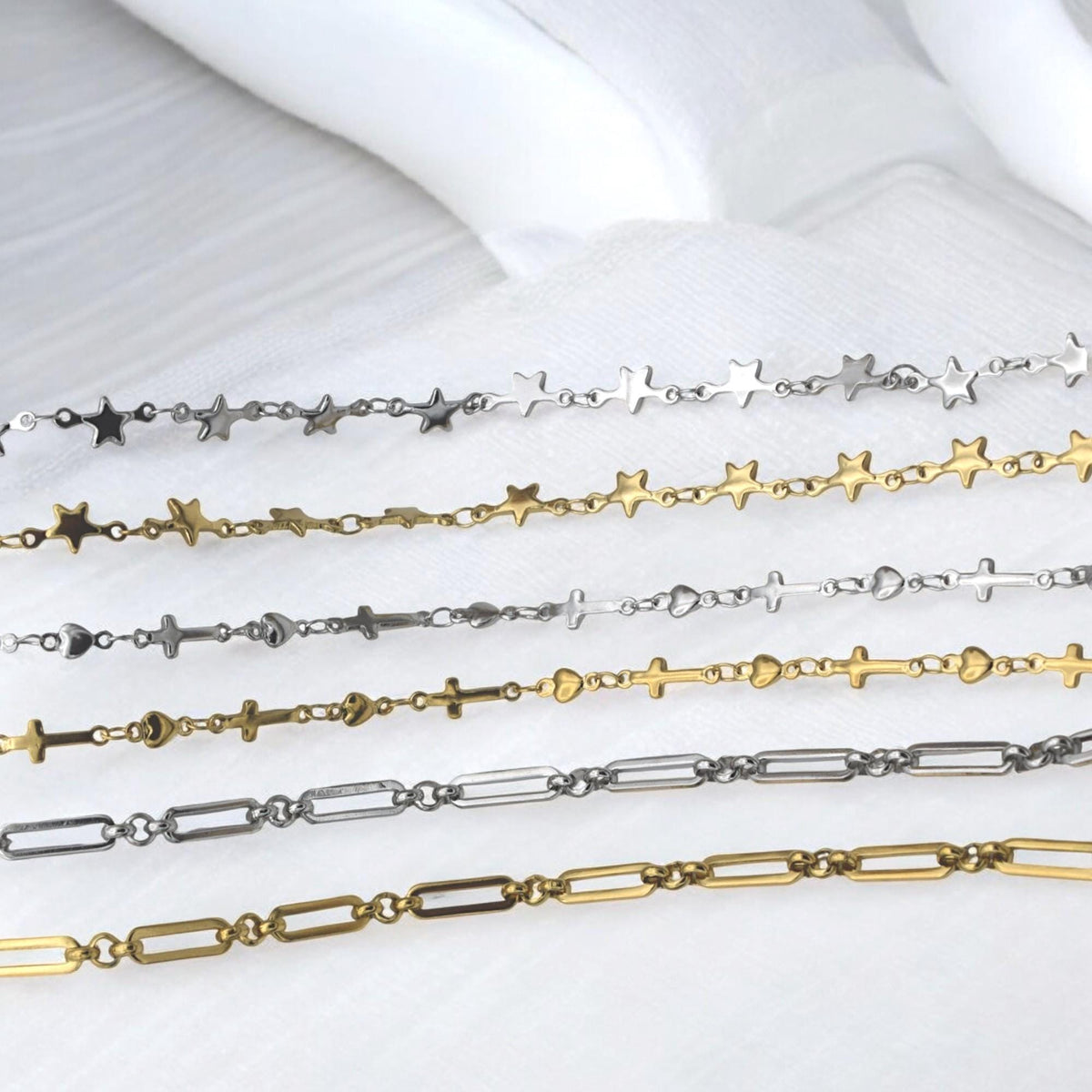 Paperclip style chain with star charms in polished gold tone for jewelry projects.