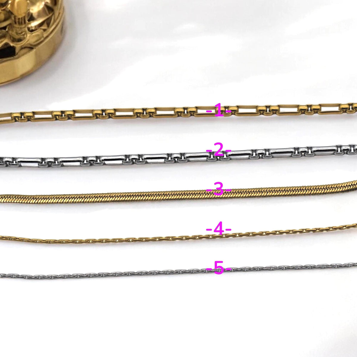 Gold and silver snake chain displayed on white background, ideal for bracelet and necklace projects.