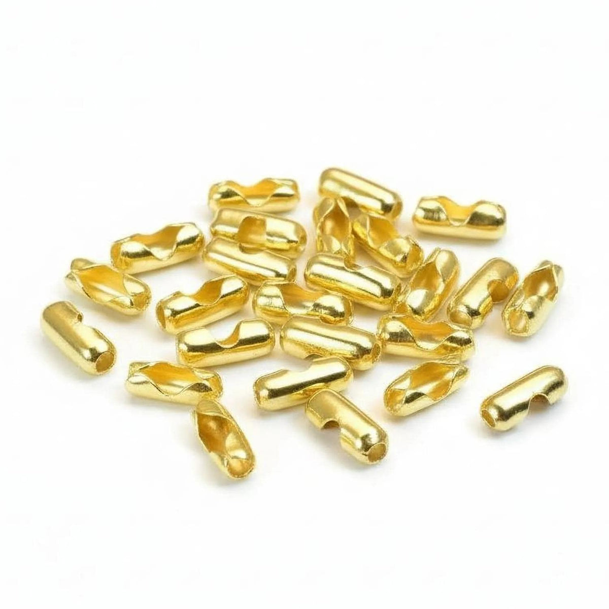 a pile of small, shiny gold-colored metal pieces scattered on a white background.