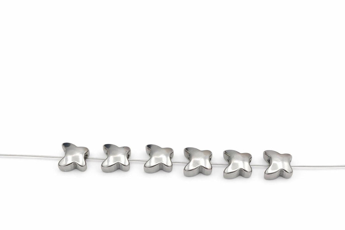 A row of silver beads on a white background.