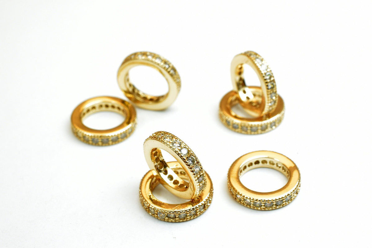 a collection of gold rings with diamond accents, arranged on a white background.