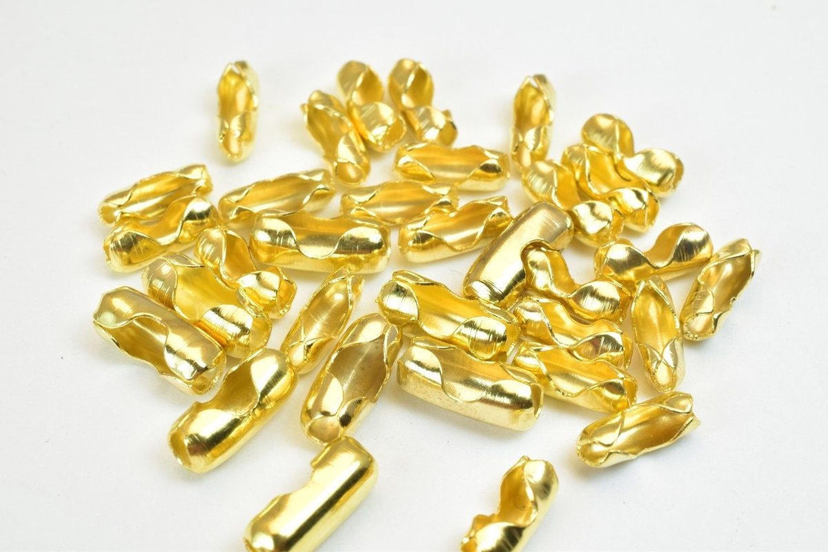 a collection of golden-colored metal pieces scattered on a white background.