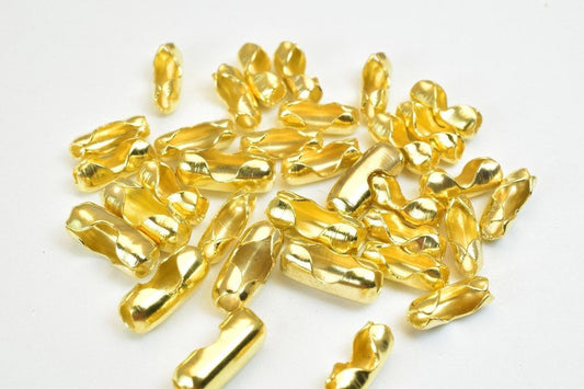 a collection of golden-colored metal pieces scattered on a white background.