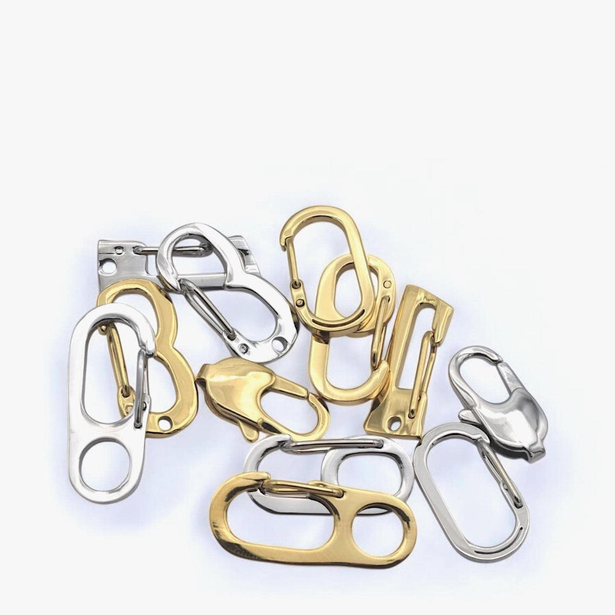 a collection of various metal clasps and hooks in different shapes and sizes, arranged on a white background.