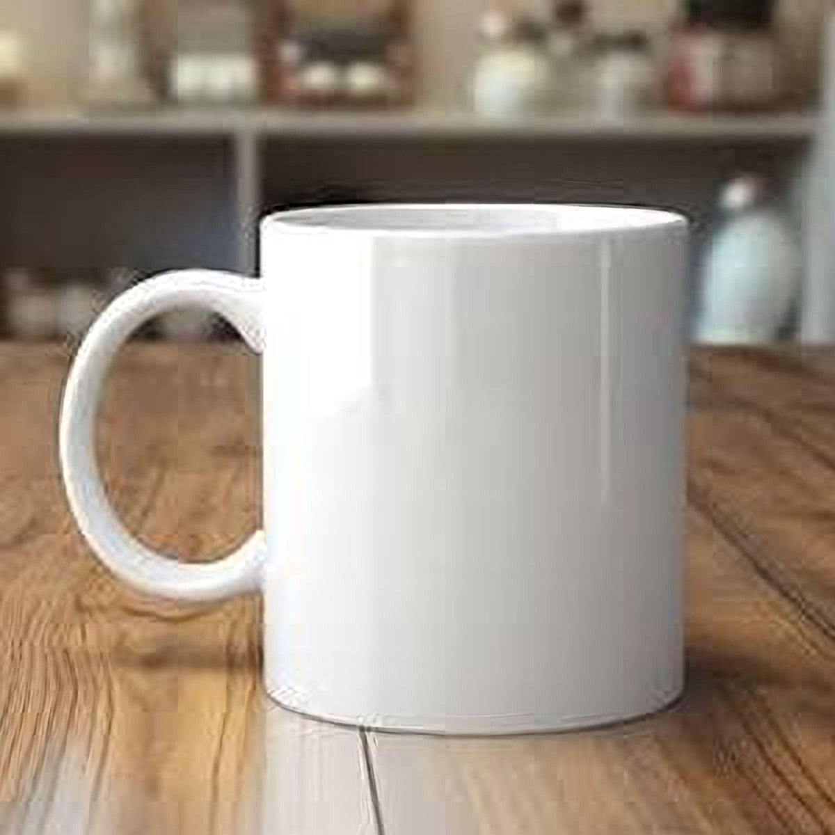 A white ceramic mug with a handle is placed on a wooden surface.
