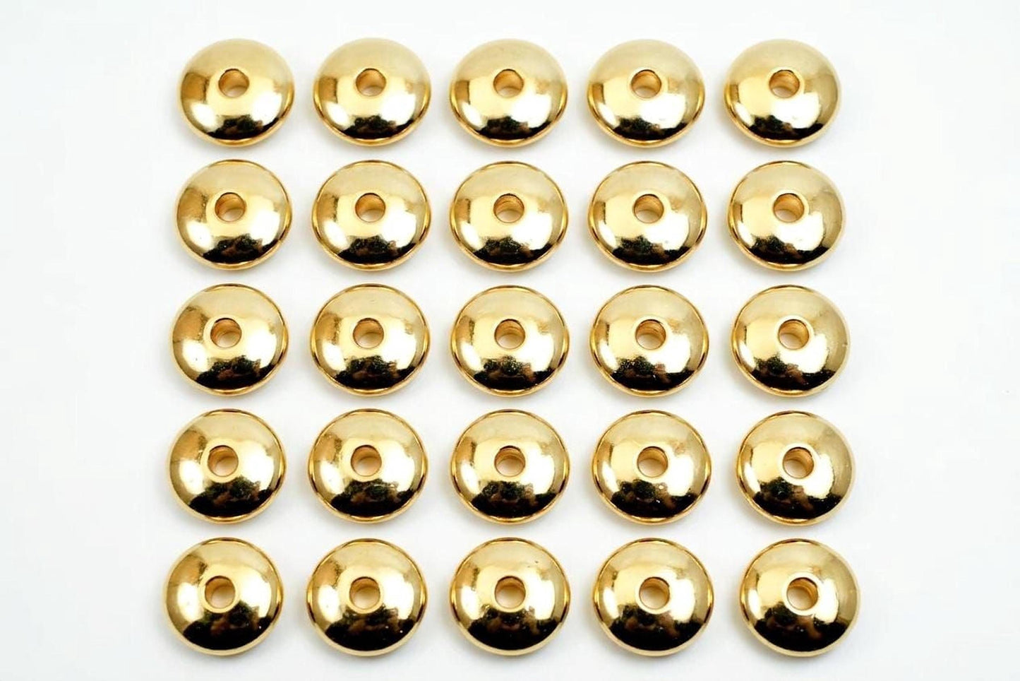 A grid of 24 shiny gold-colored circles arranged in 4 rows and 6 columns on a white background.