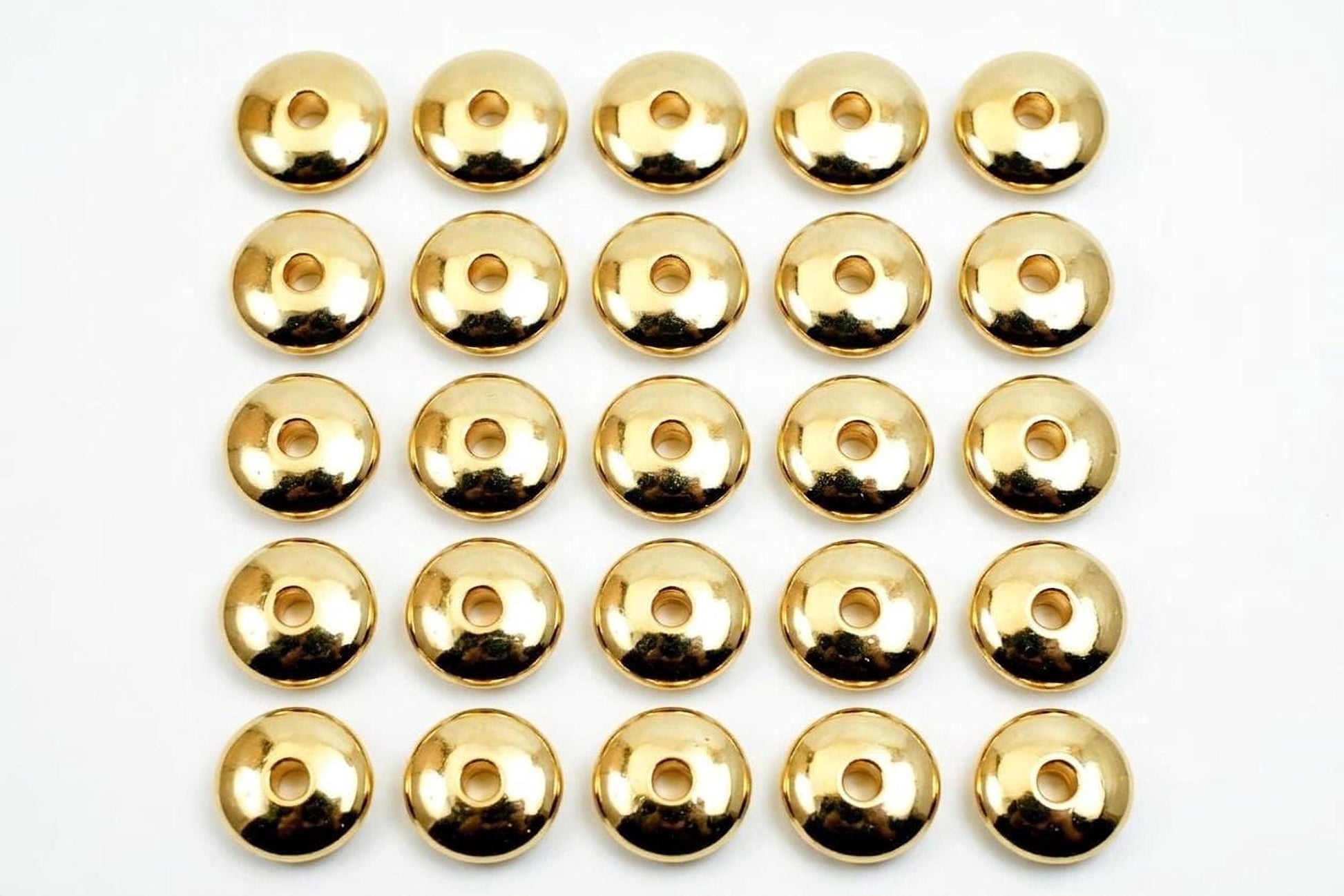 A grid of 24 shiny gold-colored circles arranged in 4 rows and 6 columns on a white background.
