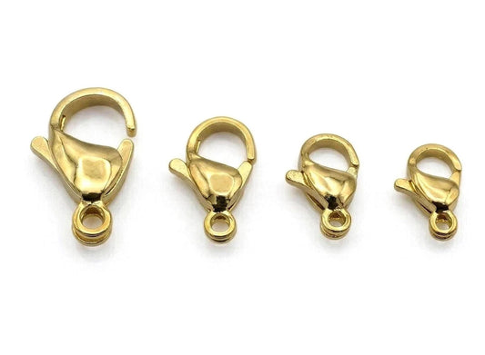 a collection of gold-colored lobster clasp locklets arranged in a row.