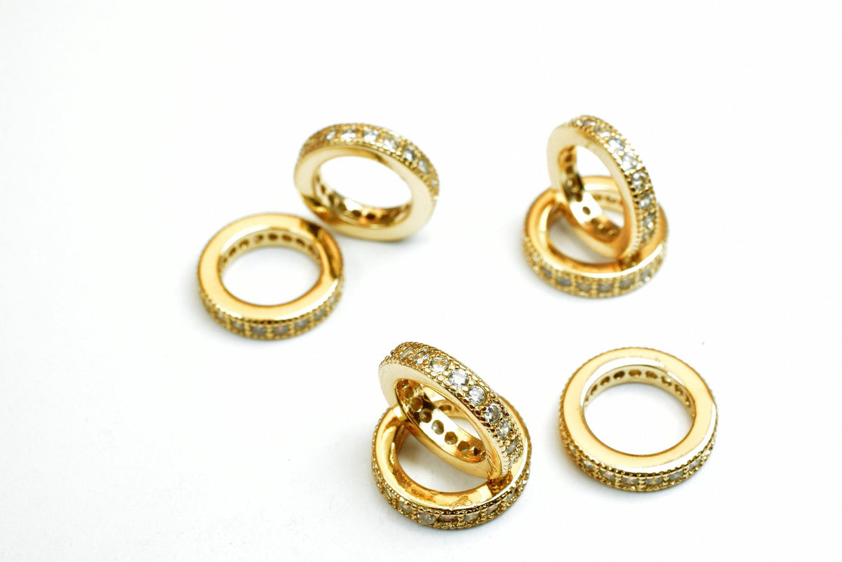 a collection of gold rings with diamond accents, arranged on a white background.