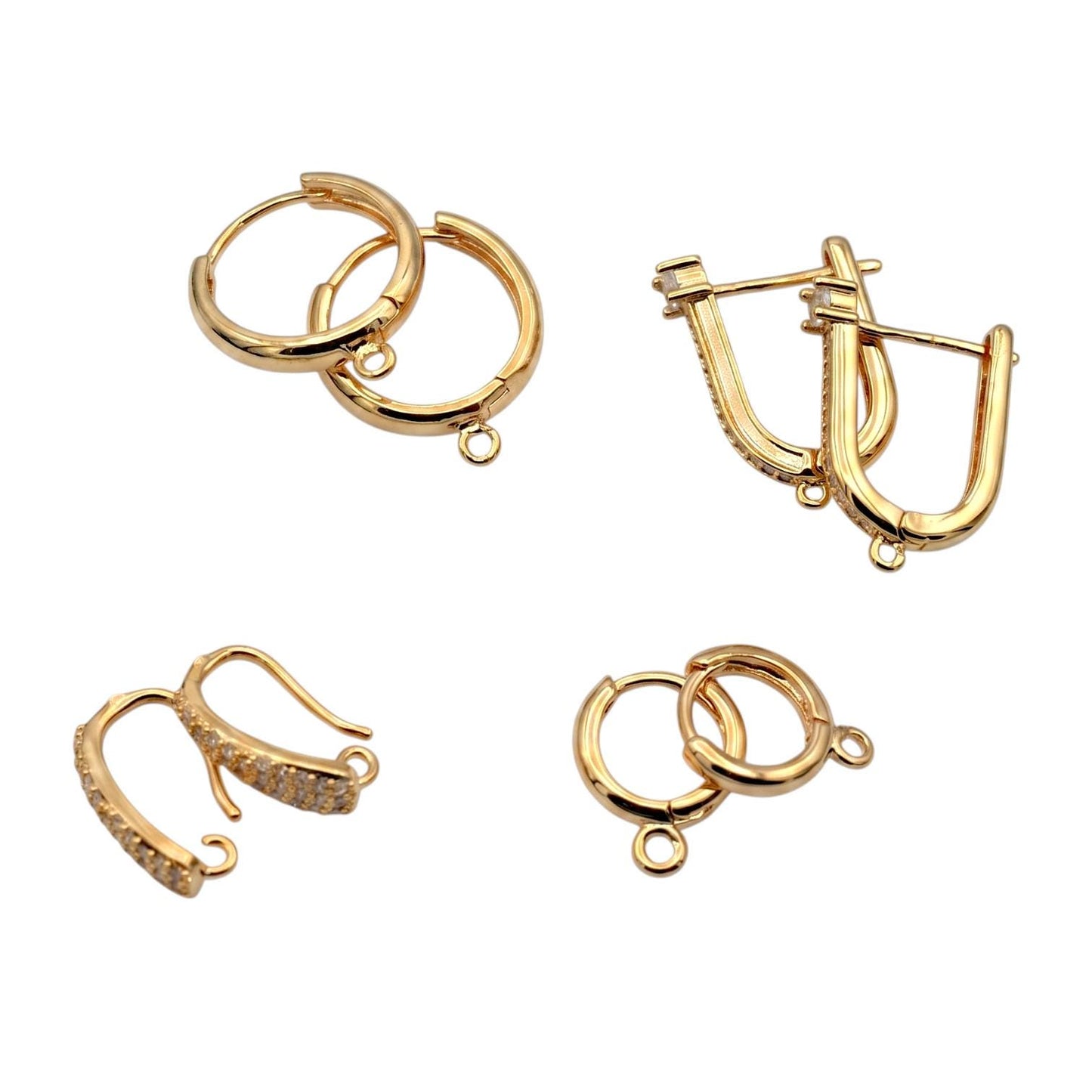 Gold hoop findings placed next to a metric ruler to show precise millimeter sizing for jewelry designers.