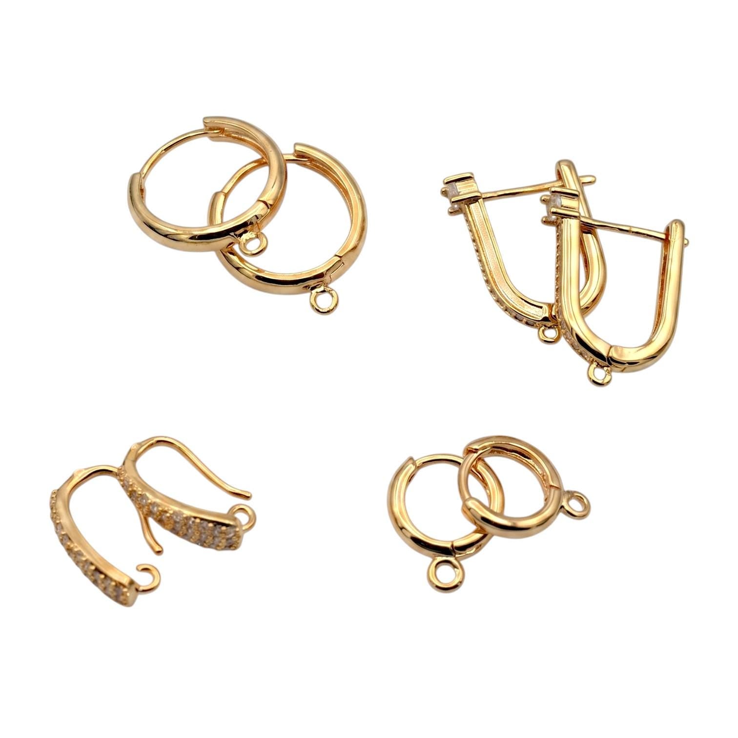 Gold hoop findings placed next to a metric ruler to show precise millimeter sizing for jewelry designers.