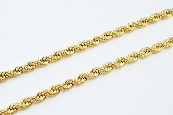 A gold rope chain with twisted links, arranged in a repeating pattern.