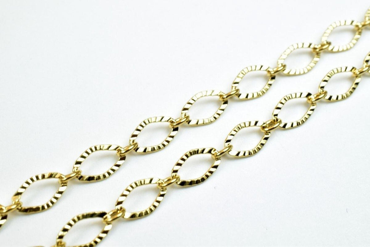 A close-up view of a gold-colored chain with multiple interlocking links.
