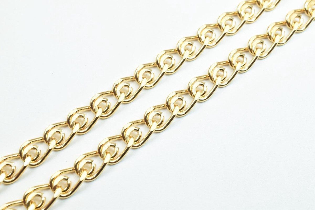 A close-up view of a gold-colored chain with interlocking links, arranged diagonally across a white background.