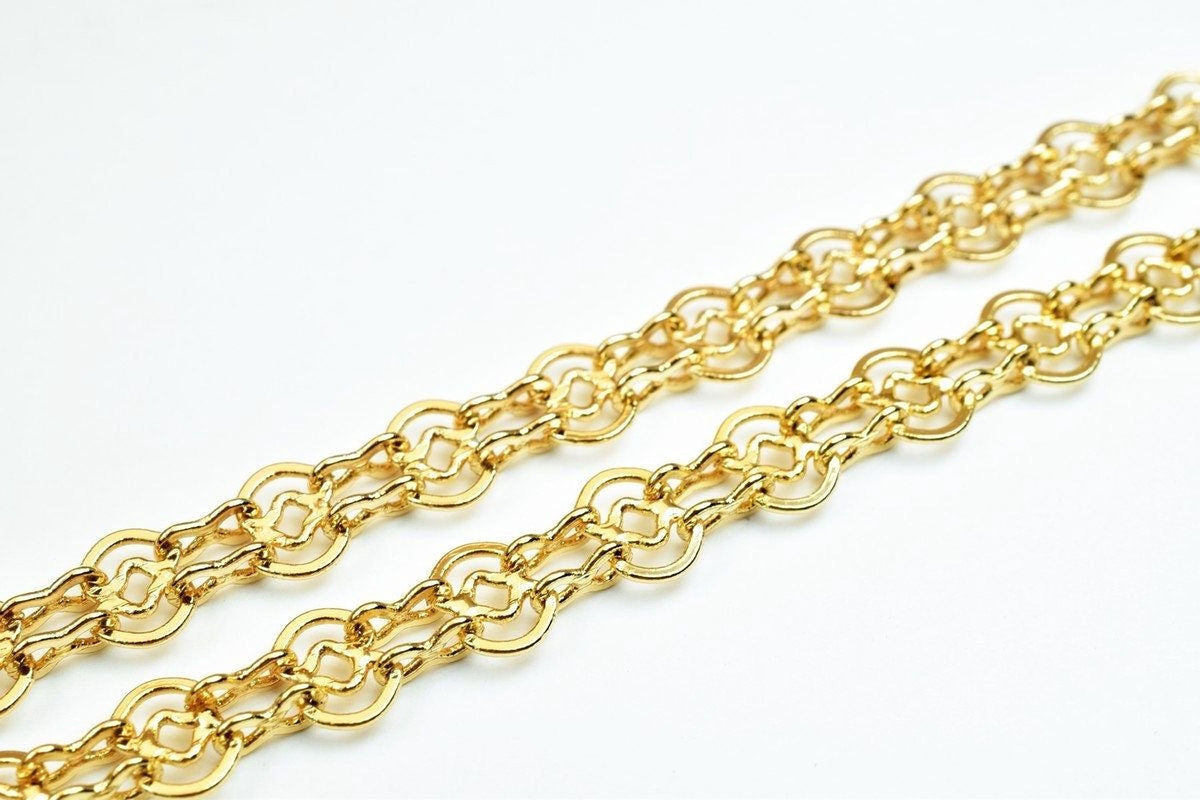 A close-up view of a gold chain necklace with multiple interlocking links.