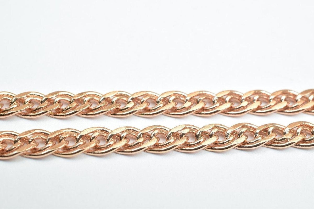 A close-up view of a gold-colored chain necklace against a white background.
