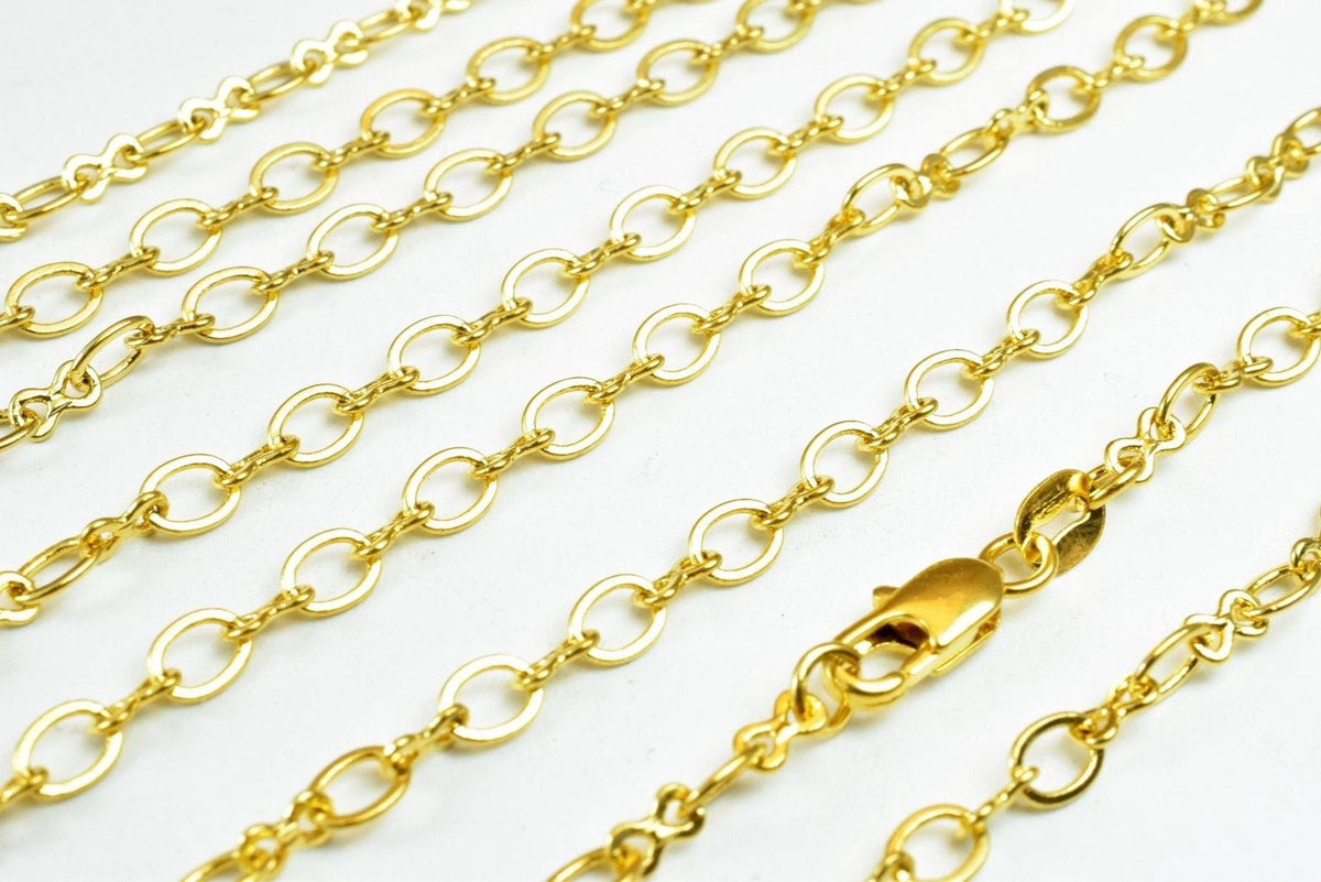 A close-up view of several gold-colored chain necklaces with a clasp visible.
