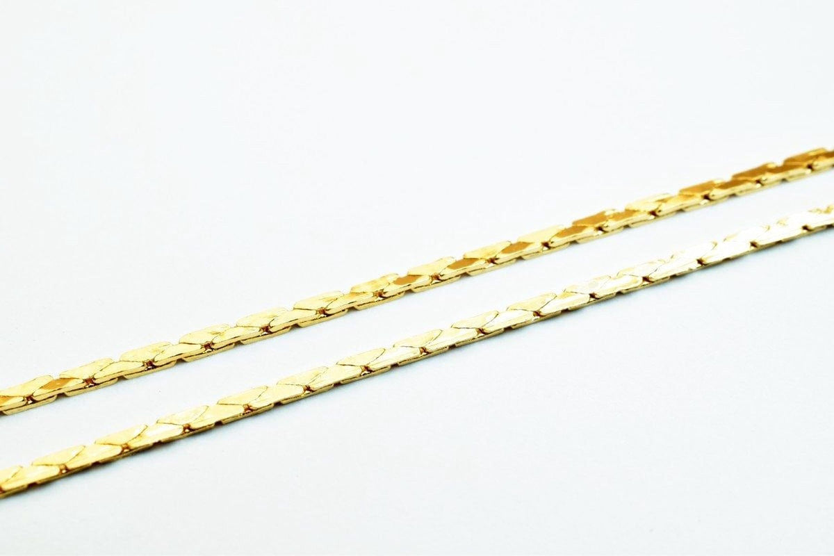 Two gold-colored metal chains are shown against a white background.