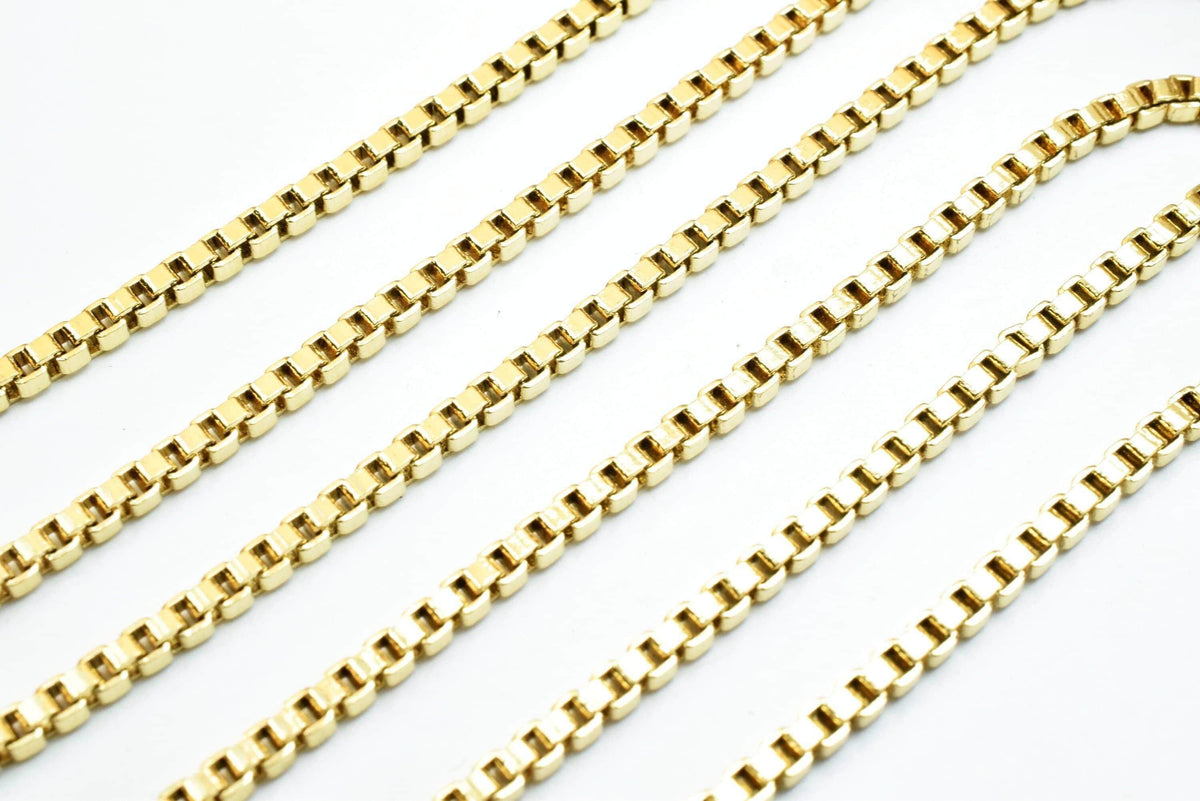A close-up image of several gold-colored metal chains arranged in a repeating pattern.