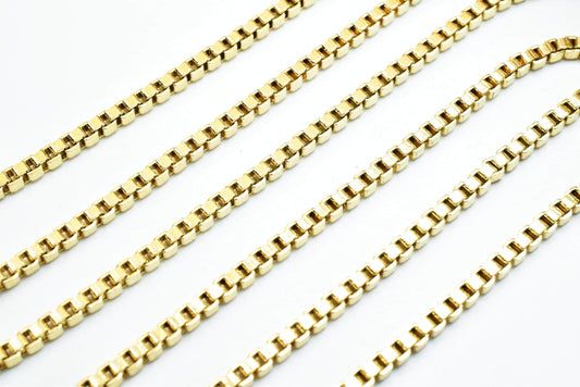 A close-up image of several gold-colored metal chains arranged in a repeating pattern.