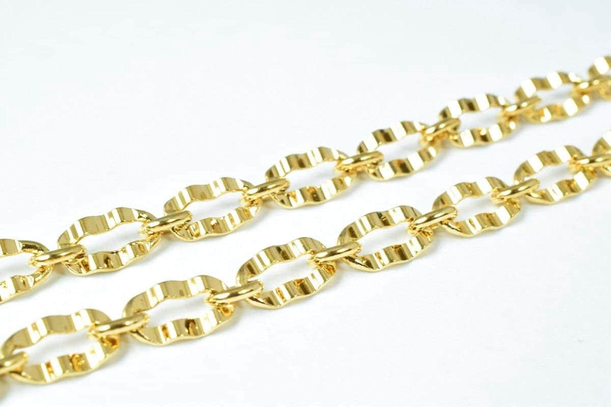 A close-up view of a gold-colored chain with multiple links, showcasing the intricate design and texture of the metal.