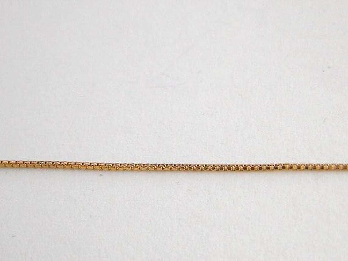 A gold-colored chain necklace is shown against a plain white background.